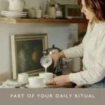 Woman Using Dualit Handheld Milk Frother to Pour Frothed Milk into a Cup in a Cozy Kitchen