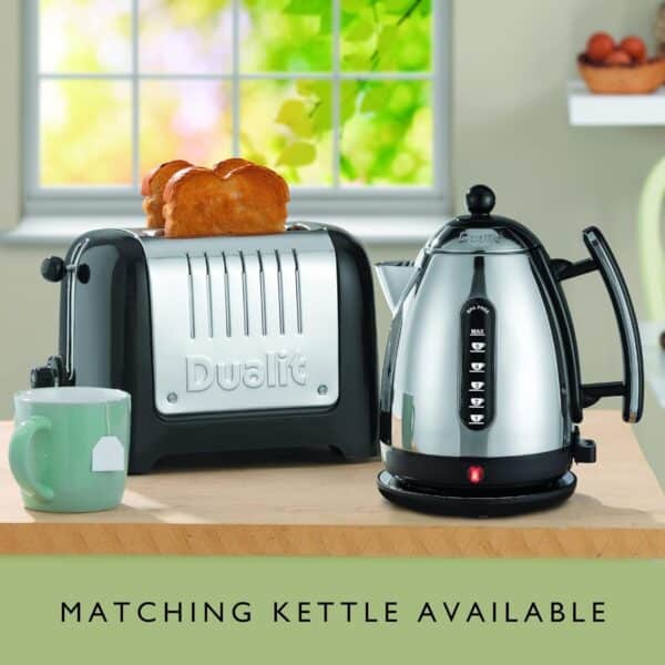 Dualit DA2625 2 Slice Lite Toaster in black with toast and matching kettle on kitchen counter.