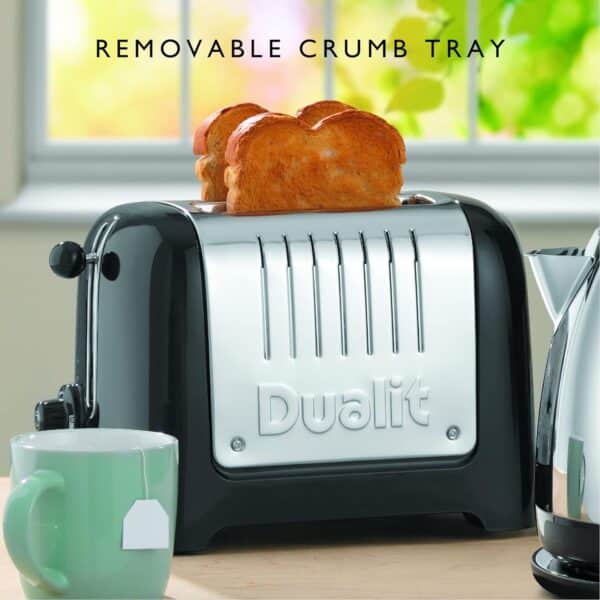 Dualit DA2625 2-Slice Lite Toaster in High Gloss Black with toast, next to a mug on a kitchen counter.
